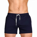 Men's solid colour swimming shorts with mesh lining for sports and fitness activities
