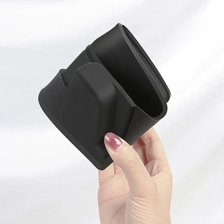 Black silicone sunglasses holder mounted on Tesla Model 3 centre console armrest