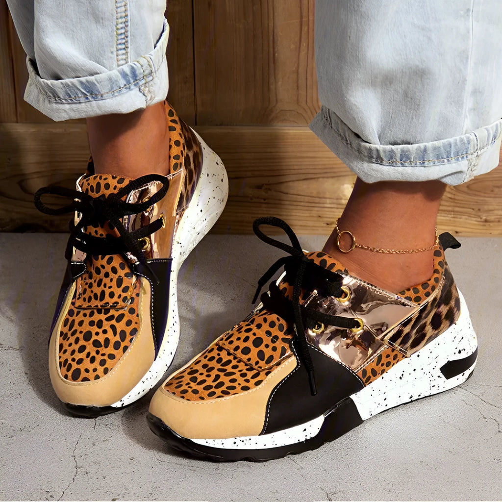Women's casual suede sneakers with a wedge heel in various colours including black, pink, and leopard print.
