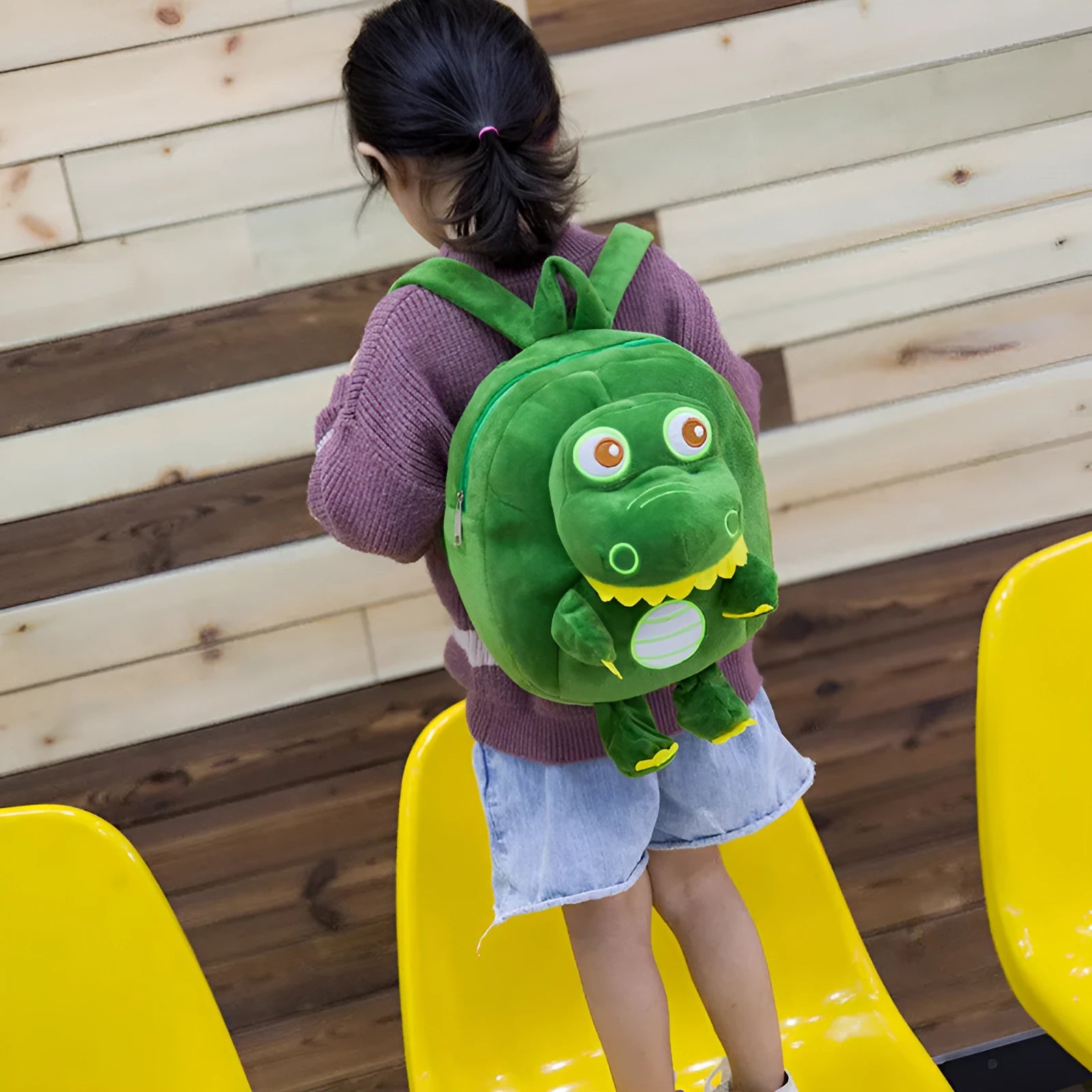Blue soft plush dinosaur children's backpack with embroidery and a soft handle.