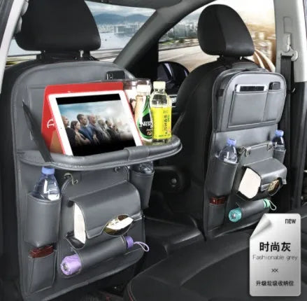 PU leather car storage bag hanging on seat back with multiple pockets and built-in trash can