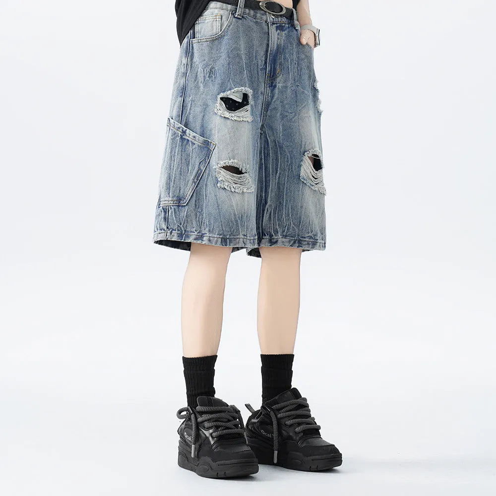 Man's ripped and washed vintage blue denim shorts with a loose, retro fit