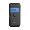 Black portable household alcohol breath tester with LCD screen on a dark background.