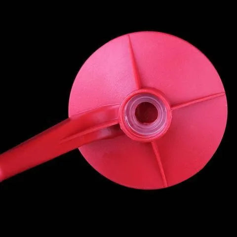 Red plastic soda dispenser attached to inverted 2-litre bottle for push-button drink serving
