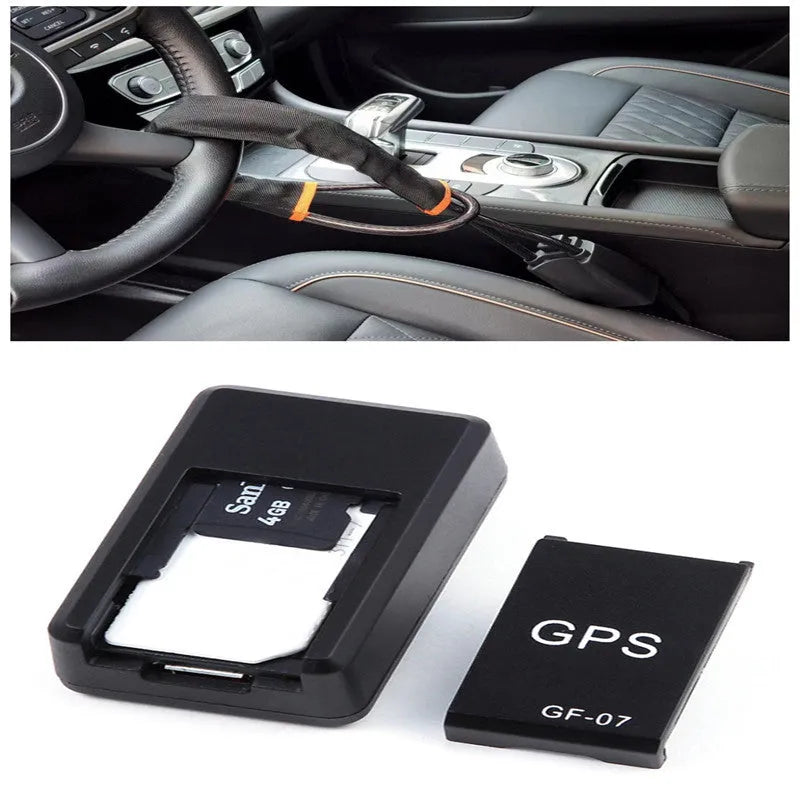 Small black plastic magnetic GPS car tracker device on a metal surface.
