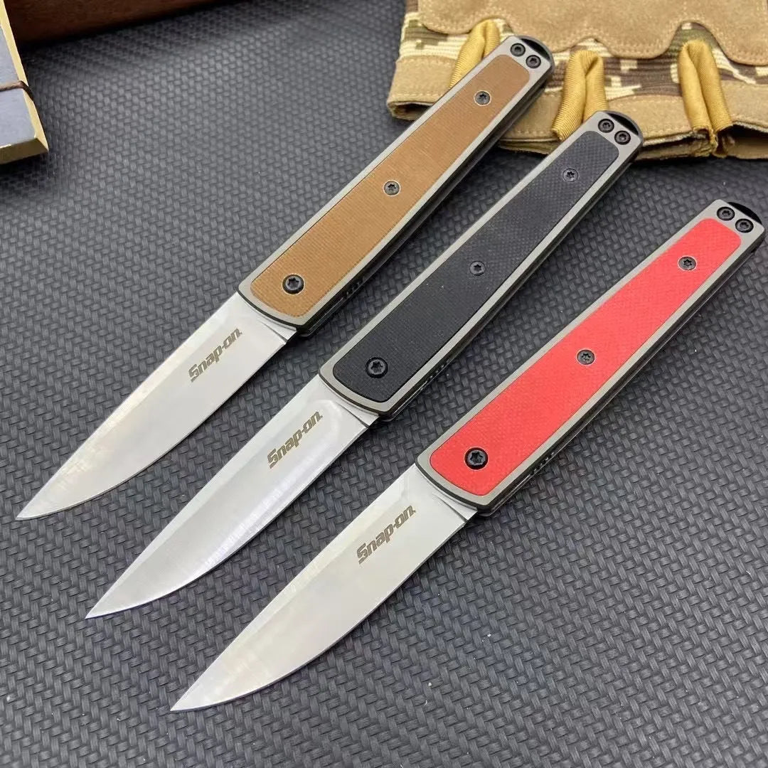 Closed and open views of a black folding fruit knife showing blade and handle.