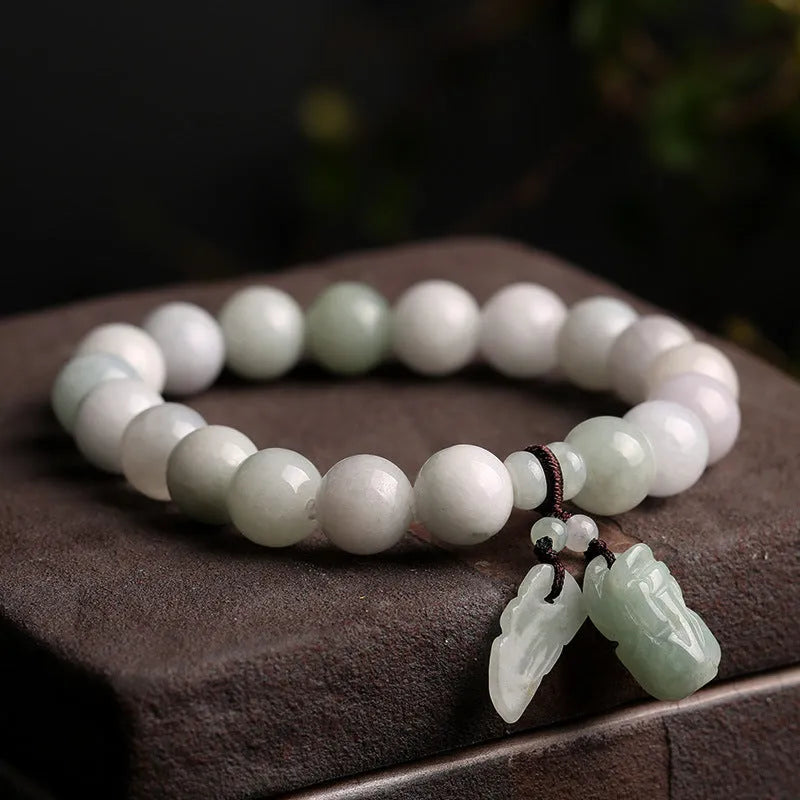 Natural emerald jade geometric bracelet with Maitreya Buddha, apple, and money bag hanging charms.