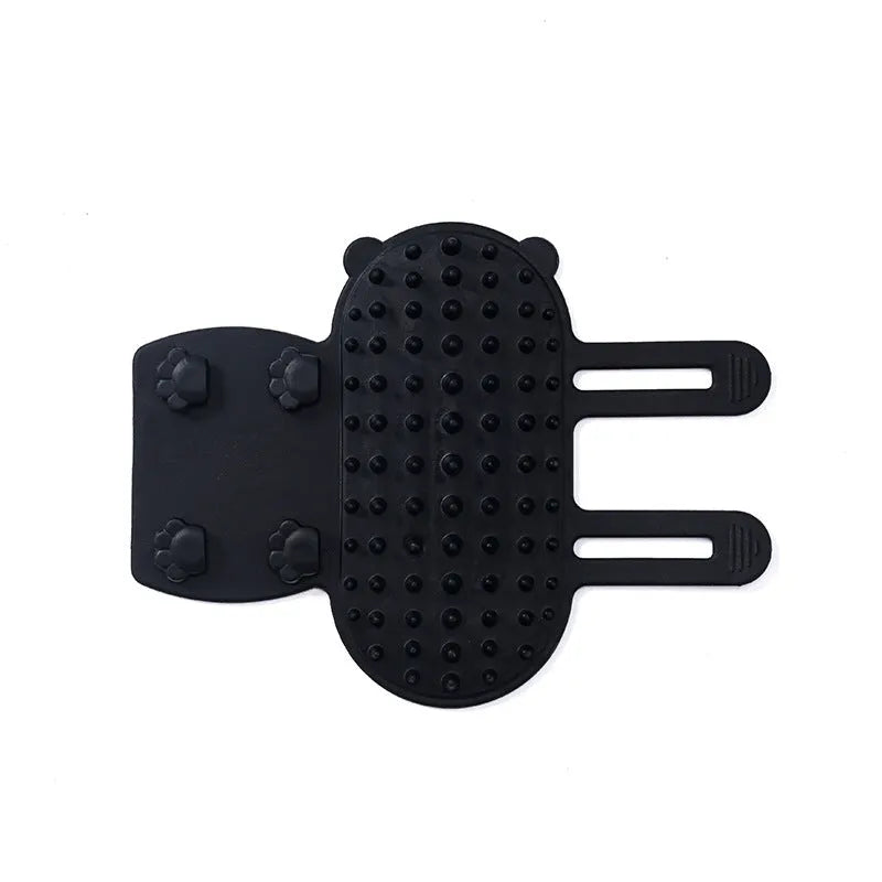 Silicone cat self-grooming brush with comb teeth and adjustable strap for table legs.