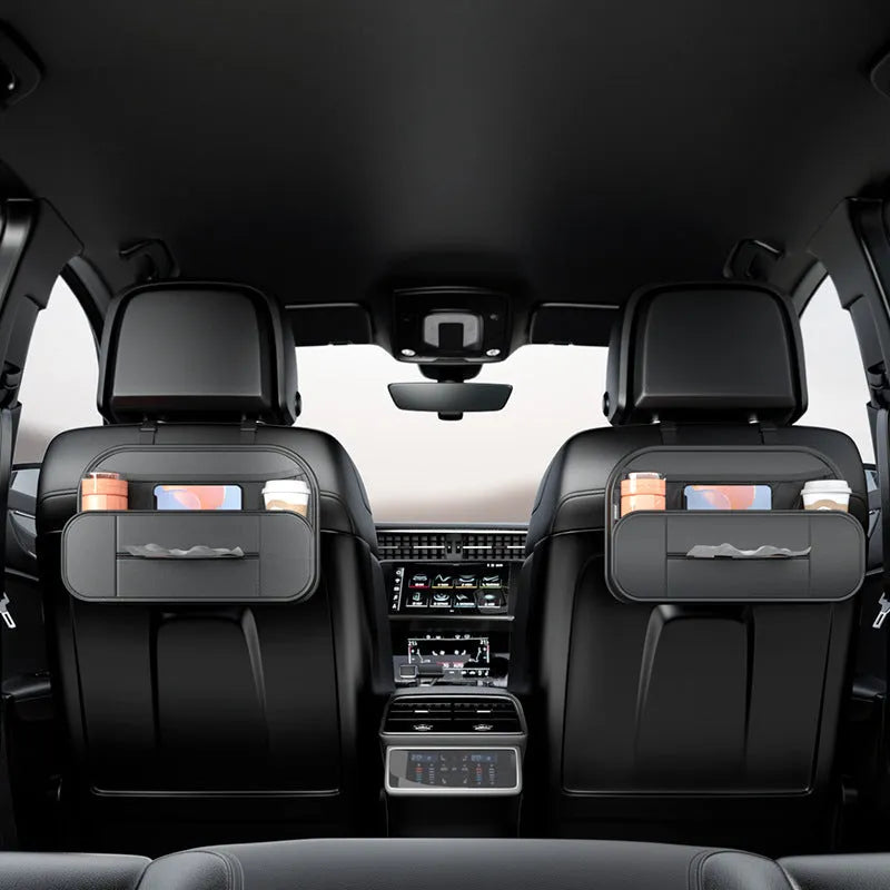 Black leather car seat rear storage bag hanging behind a vehicle seat.