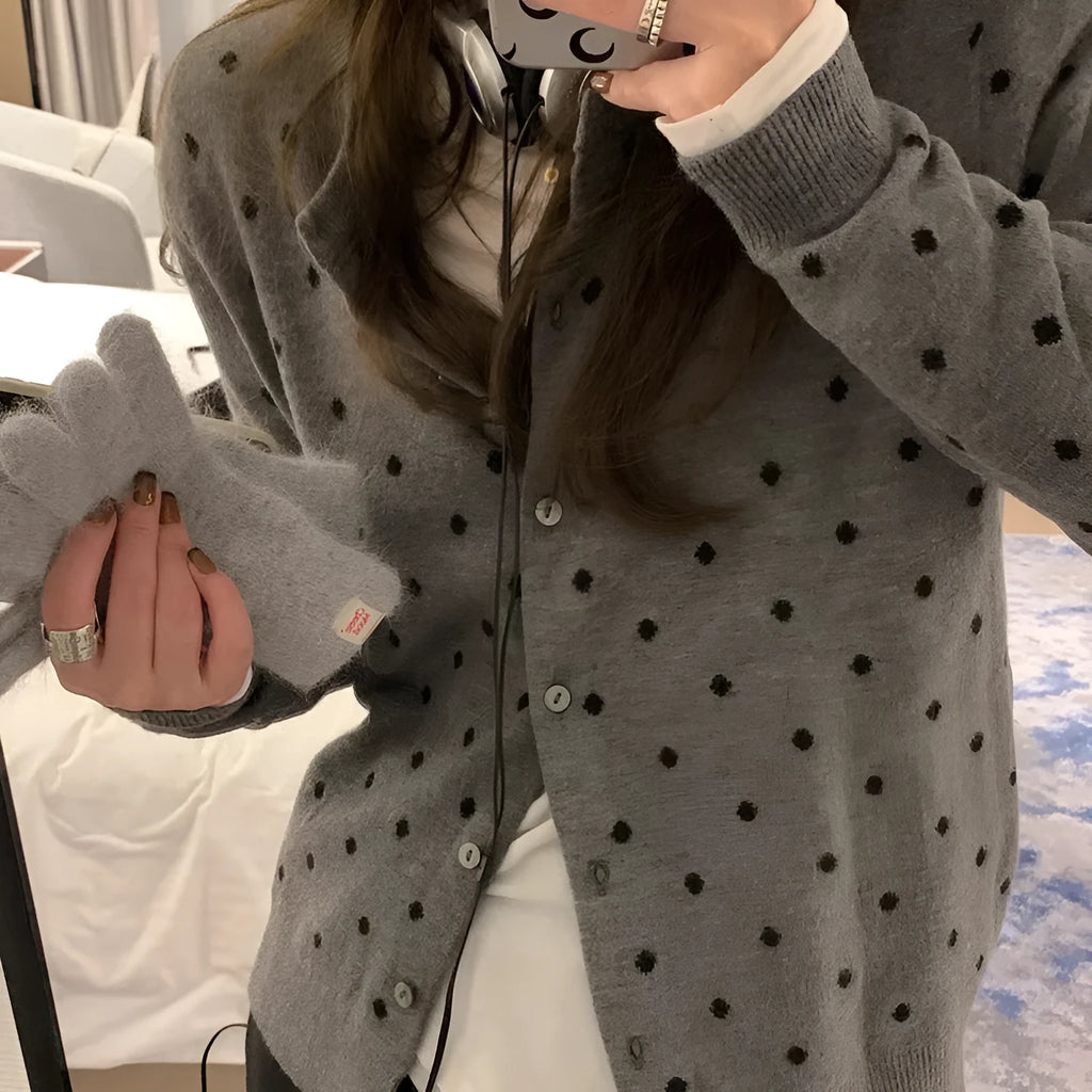 Women's grey dot pattern knitted cardigan with crocheted flower detail and long sleeves