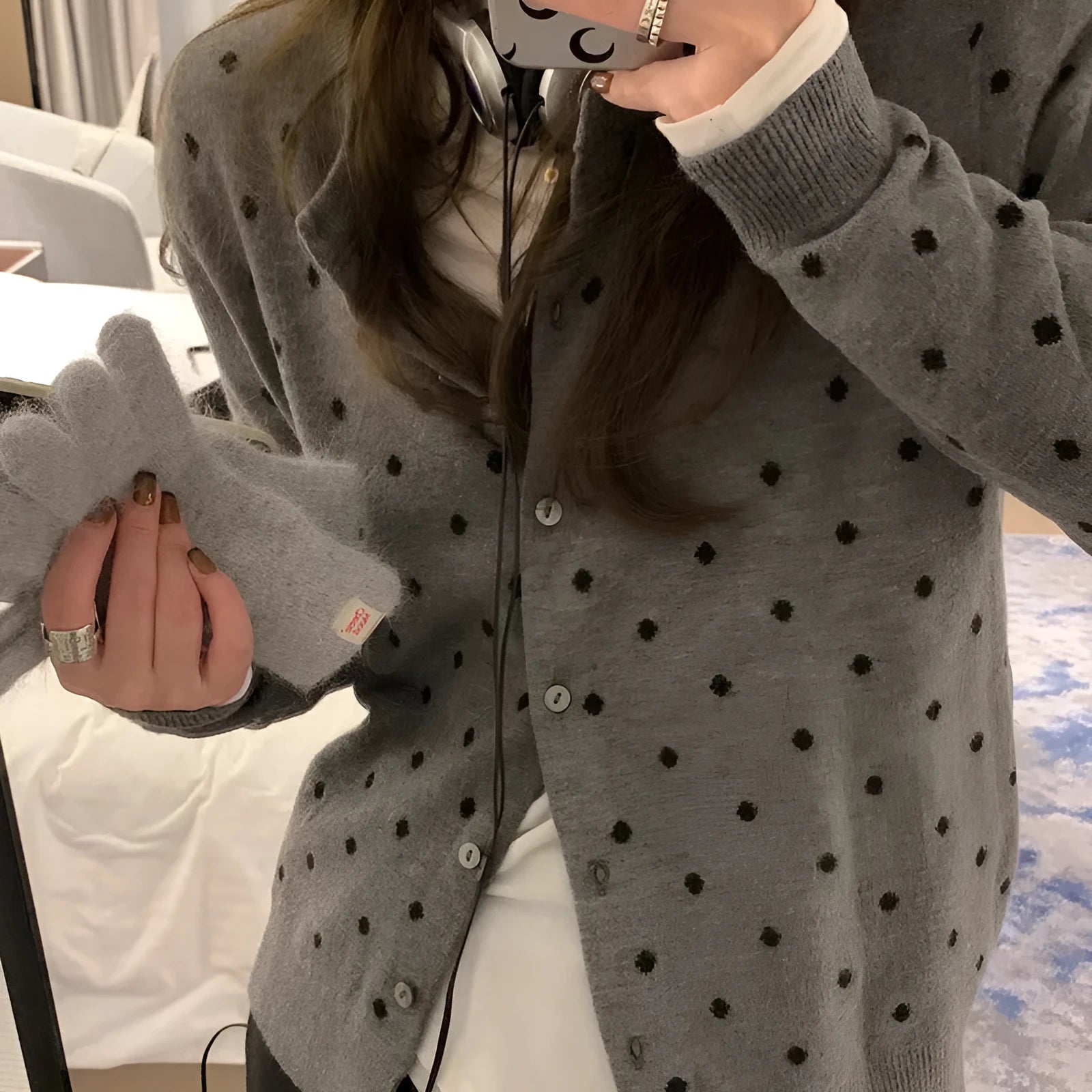 Women's grey dot pattern knitted cardigan with crocheted flower detail and long sleeves
