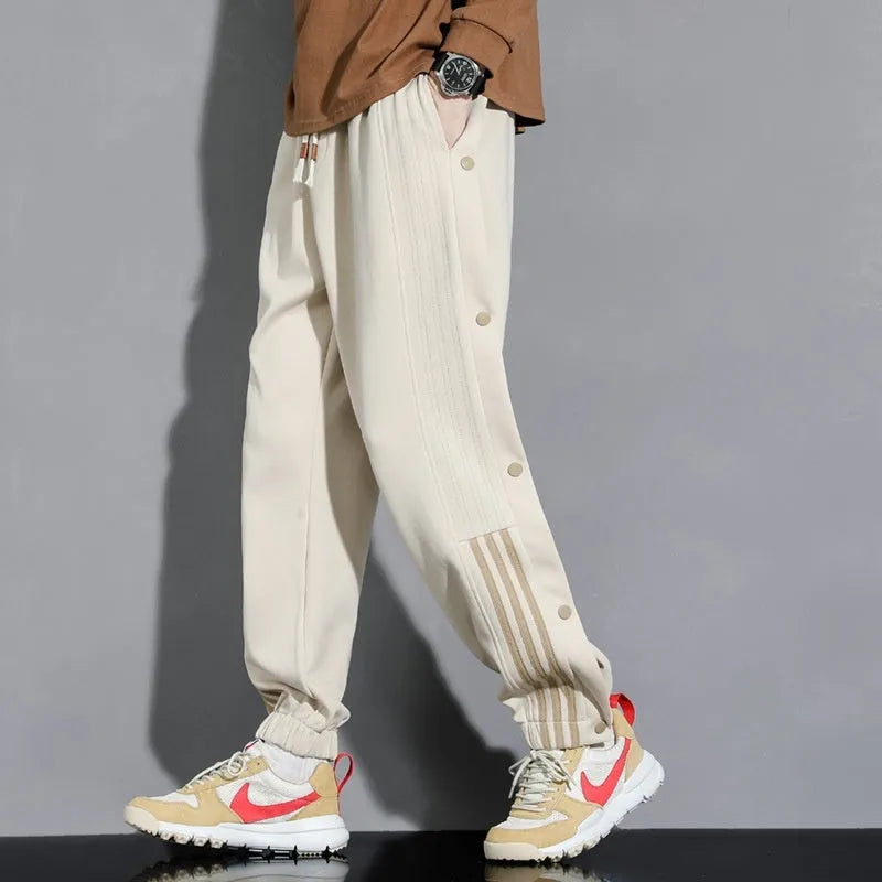 Men's loose fit cotton blend sports pants with high waist and ankle-tied cuffs in solid colours