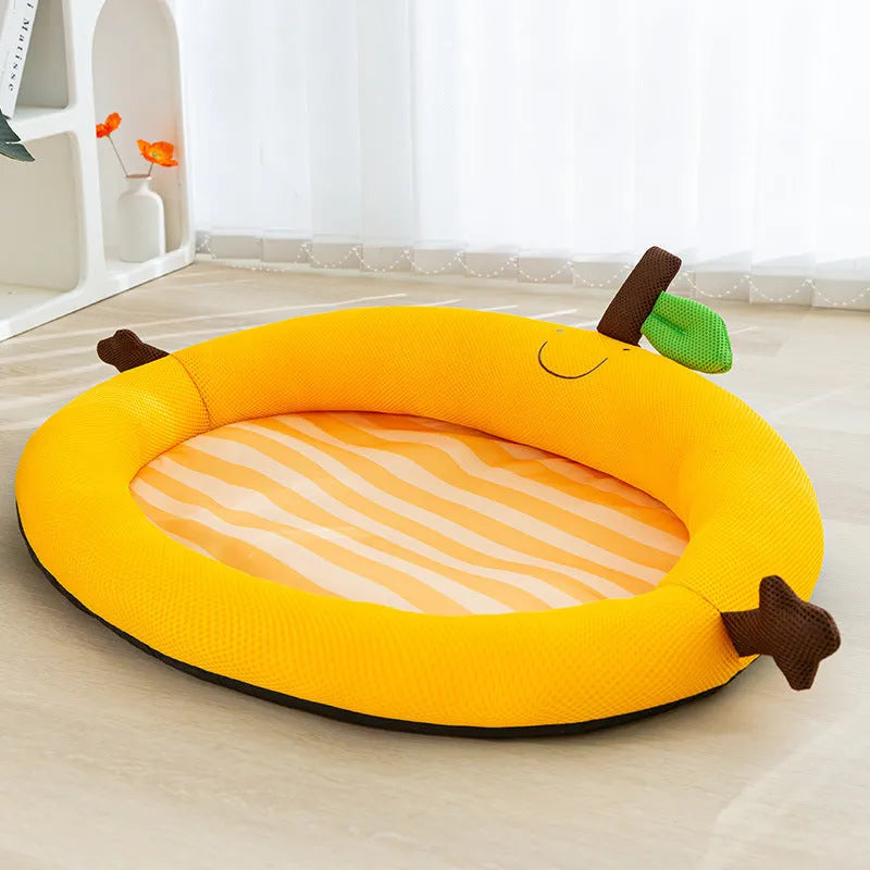 Green pet cooling mat with a raised fruit-shaped backrest, shown with a dog resting on it.