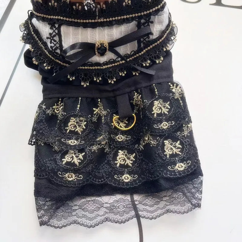 Golden gothic princess style polyester dress for a small dog on a mannequin, showing black skirt detail.