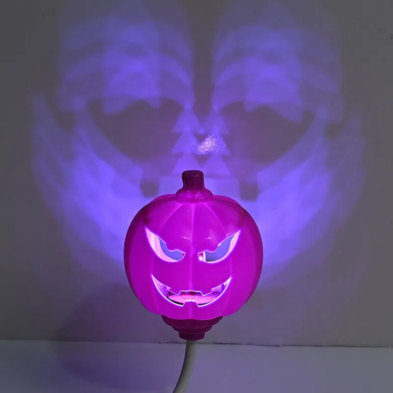 Plastic pumpkin-shaped USB lamp emitting purple or yellow light, 8.3cm wide.