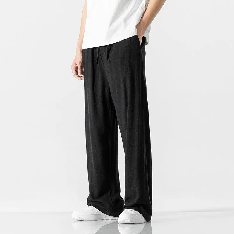 Men's beige linen casual trousers with a loose straight-leg fit and drawstring waist.