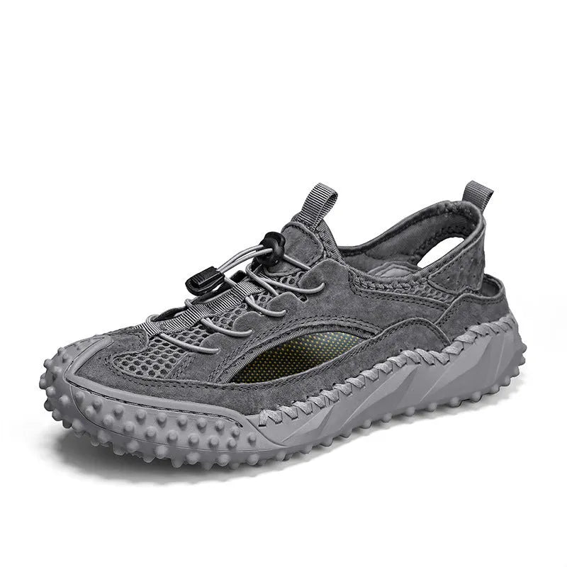 Men's black sports sandal with leather mesh upper, elastic band, and textured rubber sole.