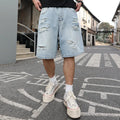 Light blue ripped denim shorts with distressed details and straight leg cut in hip hop streetwear style