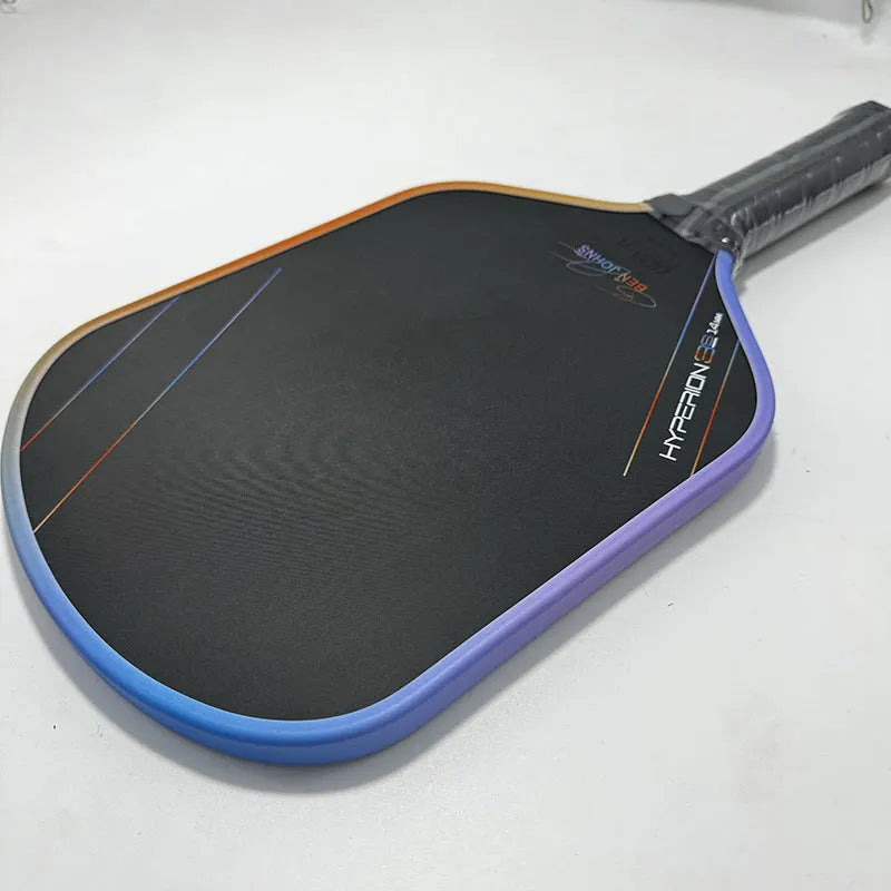 Carbon fibre pickleball racket with multi-colour matte pattern, showing 418mm length and honeycomb core construction.