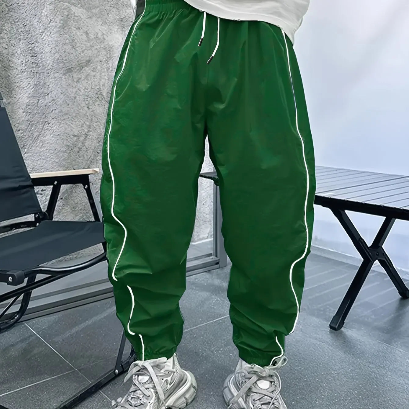 Man wearing blue bamboo fibre casual trousers with a cropped leg and loose fit.