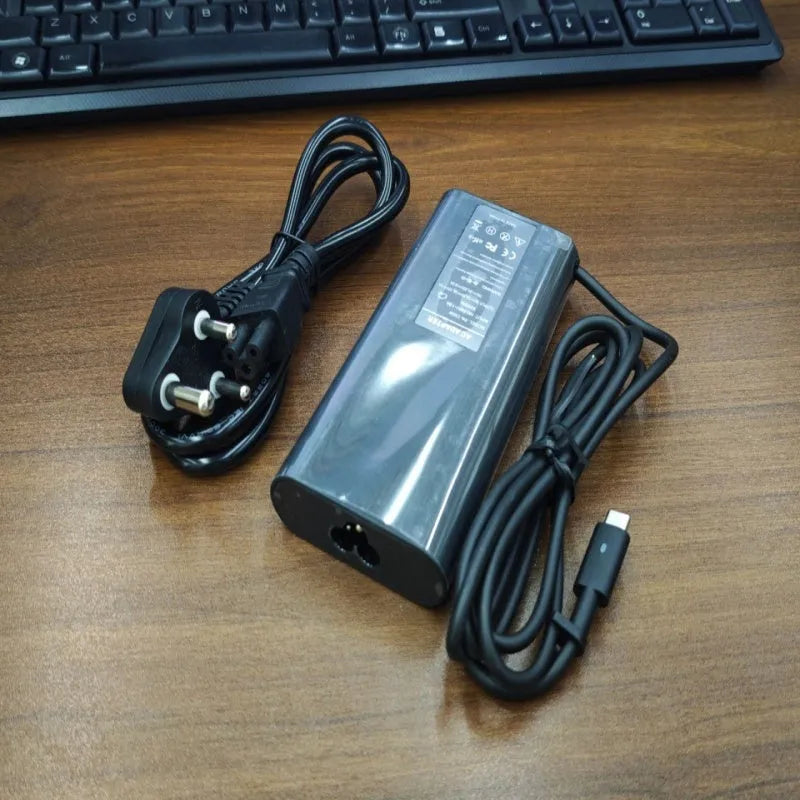 Black 65W Type-C laptop power adapter with multiple international power cords