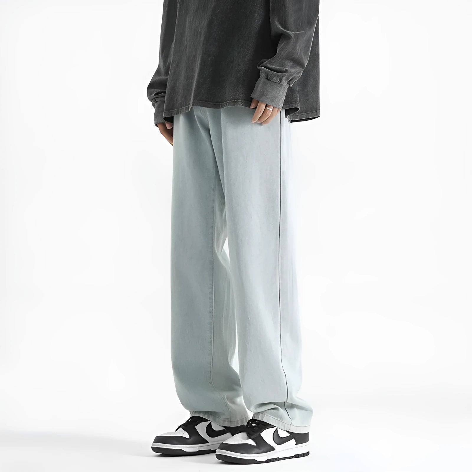 Men's light blue washed cotton straight leg jeans with button waist, laid flat.