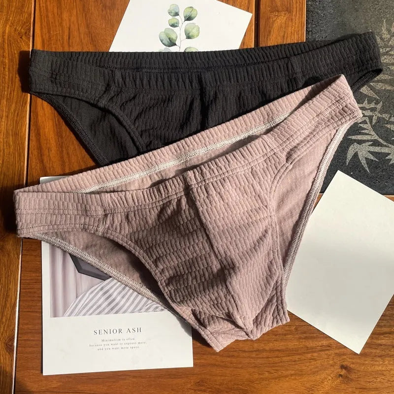 Men's solid colour cotton triangle underwear briefs with mid waistband, shown in apricot black colour.