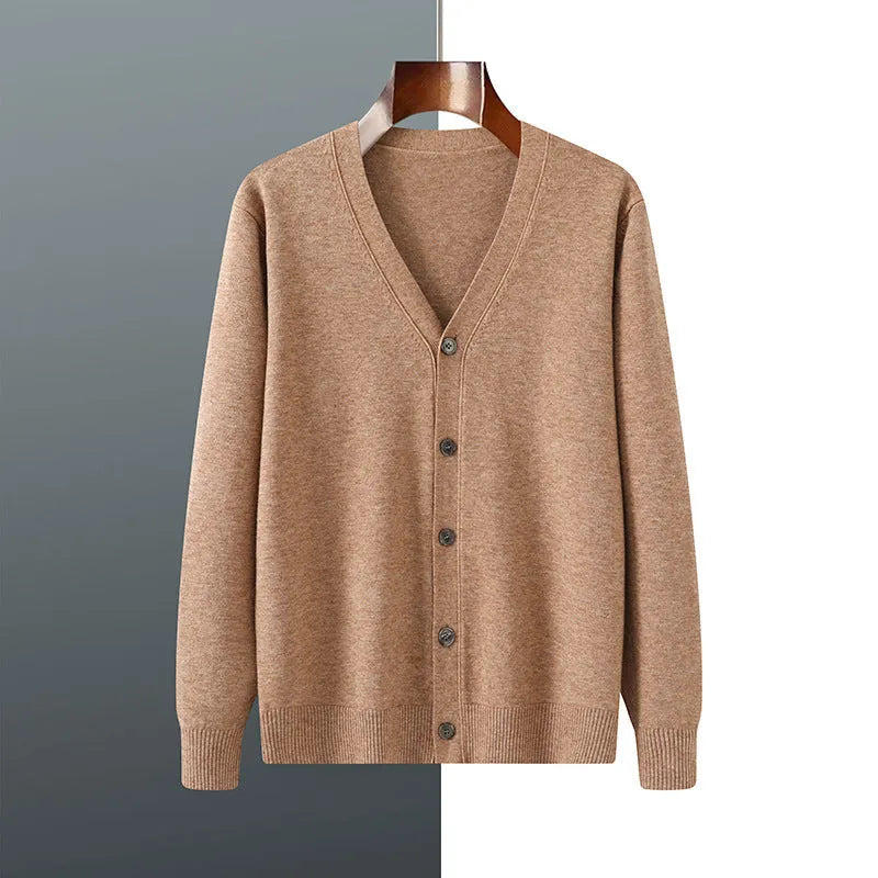 Man wearing a beige V-neck Andy velvet knitted cardigan coat with long sleeves and a loose fit.