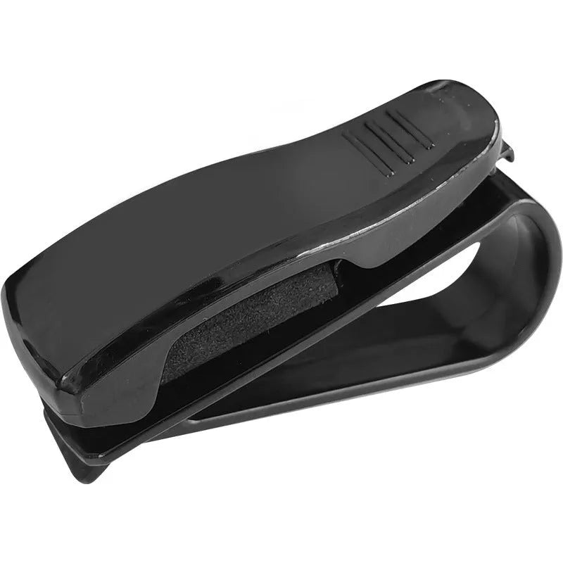 Black plastic clip for holding glasses and cards on a car sun visor.