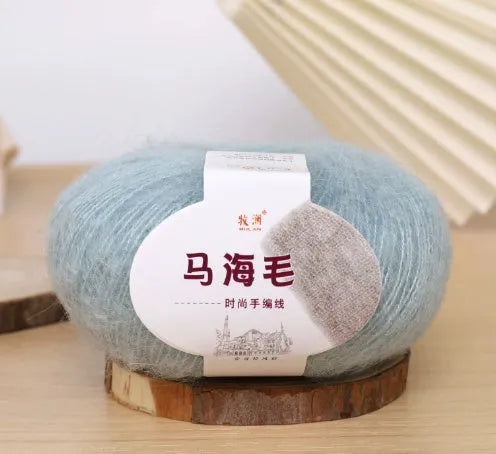 Single ball of mohair yarn in various colours for hand-woven DIY scarf knitting projects