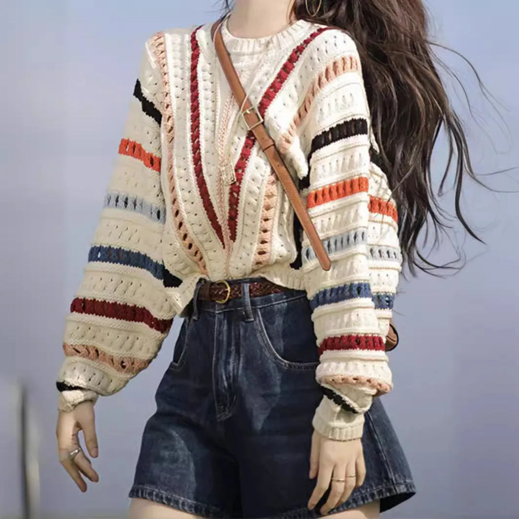Colourful retro rainbow striped loose sweater with batwing sleeves on a hanger