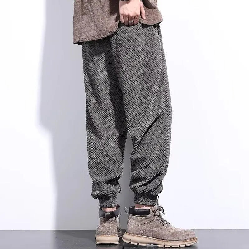 Men's grey ankle-tied casual sweatpants with a light straight leg on a neutral background.