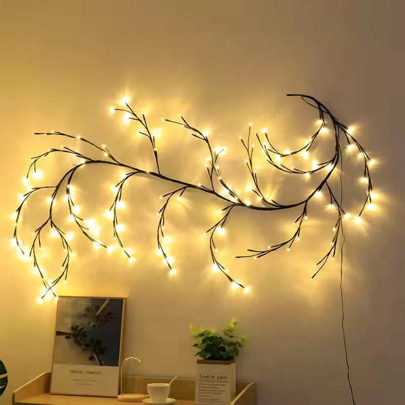 Flexible willow vine LED garland with birch bark texture and warm white lights shaped on a wall.