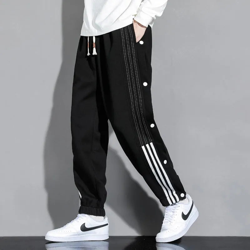 Men's loose fit cotton blend sports pants with high waist and ankle-tied cuffs in solid colours