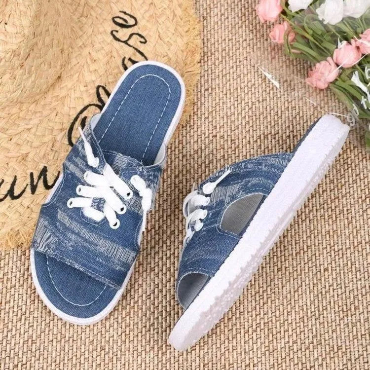 Blue women's flat canvas Roman style slippers with a cloth upper and rubber sole.