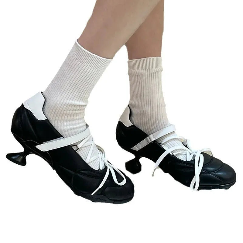 Women's silver lace-up sports shoes with a decorative bow and platform sole, showing round toe and low-top design.