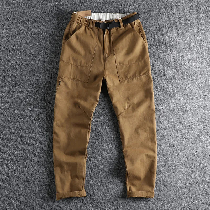 Men's khaki work trousers with a buckle belt and three-dimensional cutting on a hanger.