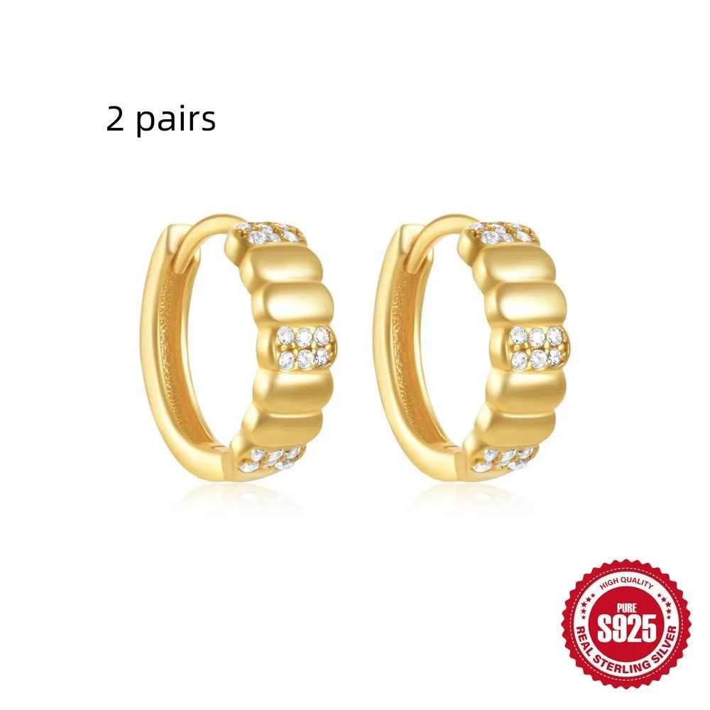 Sterling silver geometric stud earrings with small round diamond detailing in gold and silver electroplated finishes