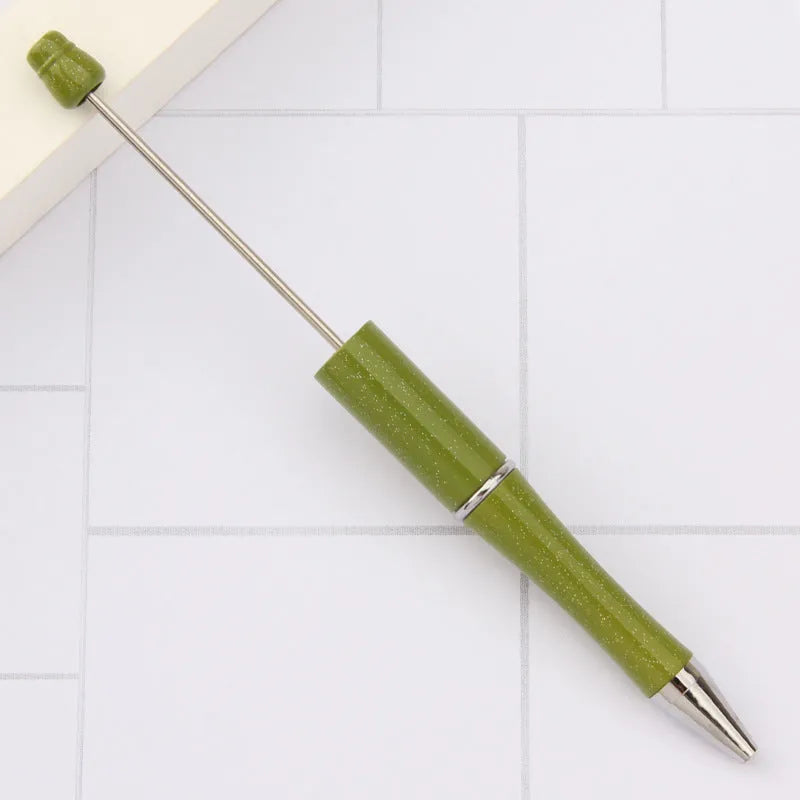 Creative ballpoint pen with multicoloured spinning plastic beads on a steel wire frame.