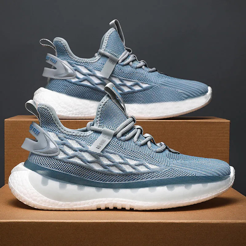 Men's low-top white mesh sneakers with a rubber sole and round toe on a plain background.