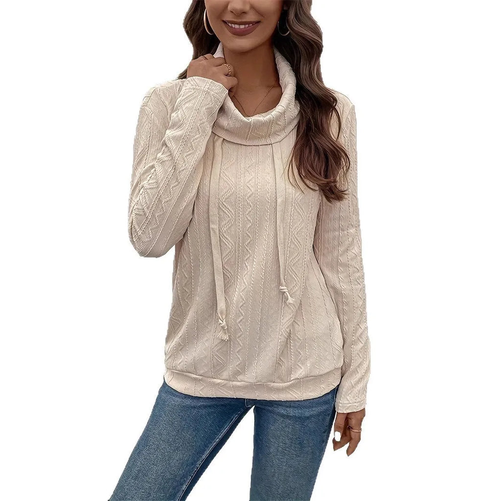 Apricot coloured long sleeve hooded pullover sweater with a drawstring, shown on a hanger.