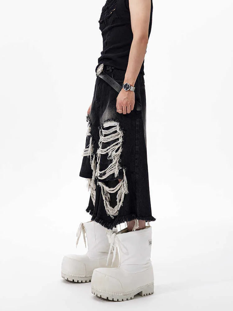 Black women's cropped wide leg jeans with a distressed patch detail on the leg.