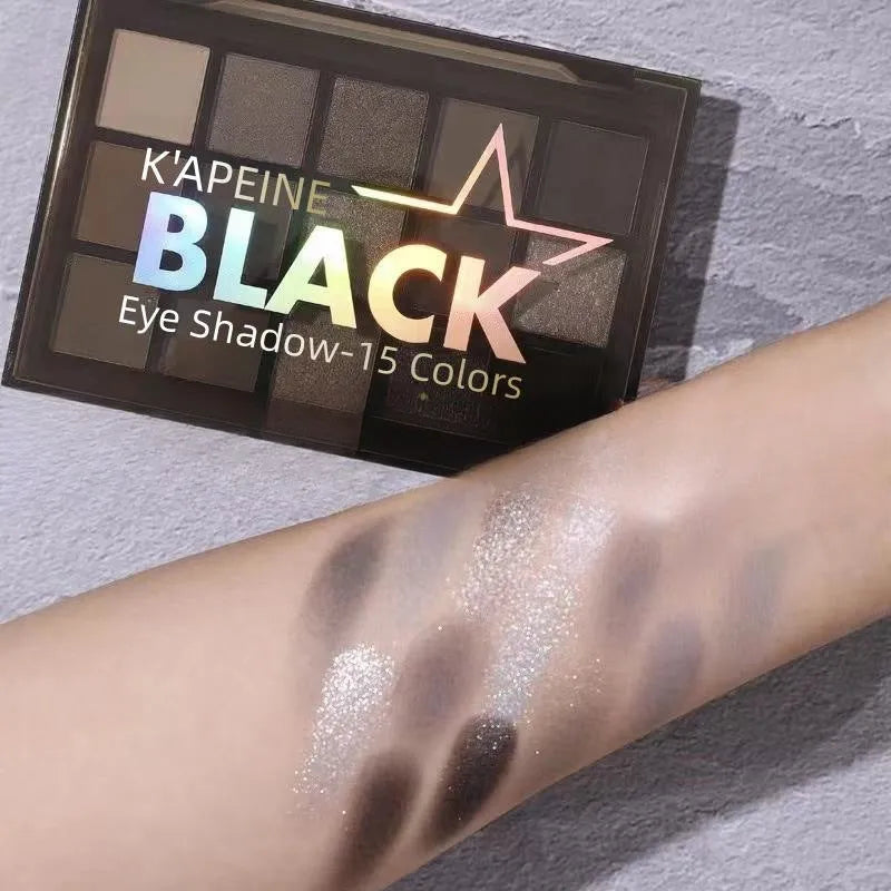 15-colour eyeshadow palette open, showing pans of shimmer, matte, grey, brown, and blue eyeshadows.