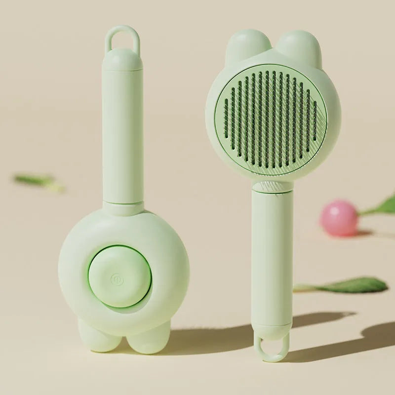 Self-cleaning pet grooming brush in green with stainless steel comb and release button.