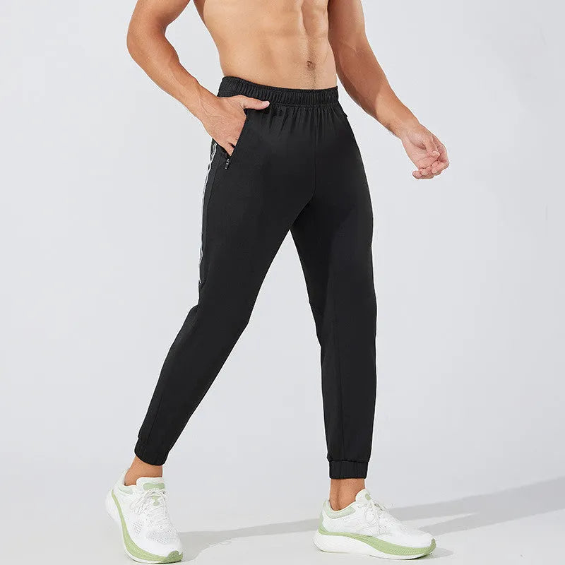Men's black running trousers with mid-waist design and full-length polyester construction for sports