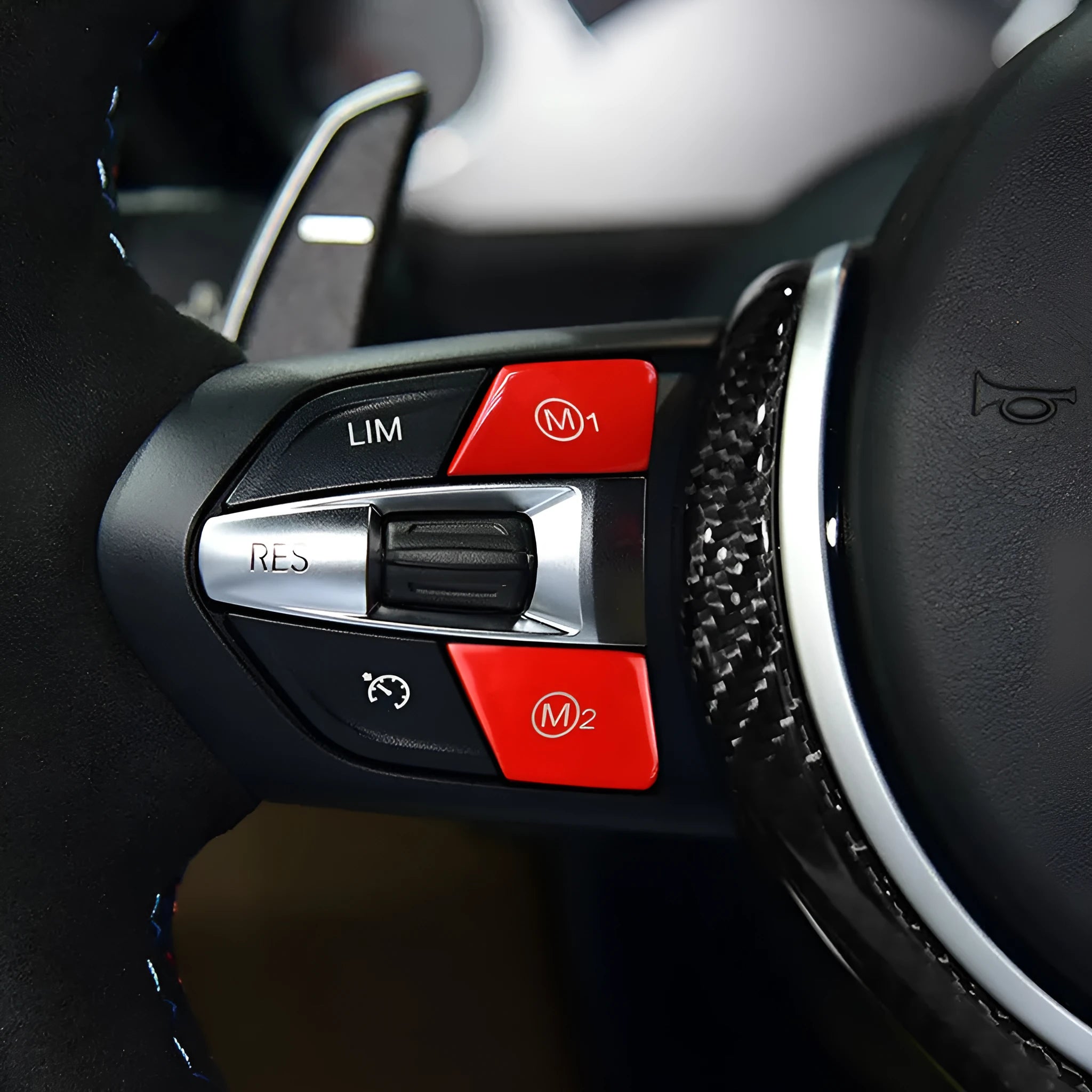 Pair of red and blue BMW steering wheel M1 and M2 mode replacement buttons on a white background.