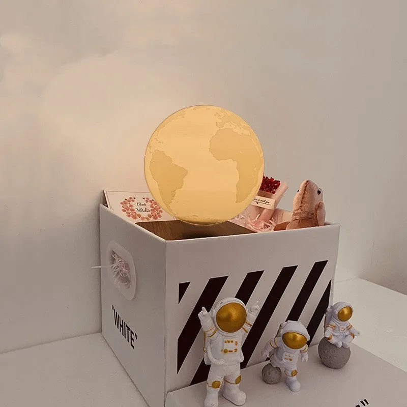 Floating magnetic levitation moon planet lamp with LED light and astronaut figures on desk