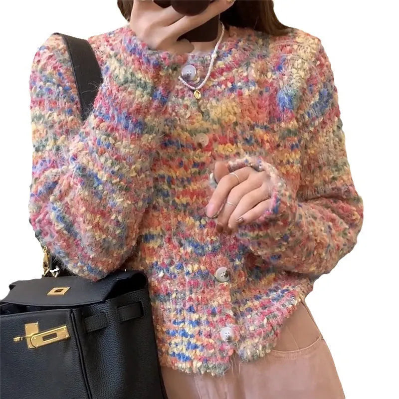 Pink and green retro style slim-fit knitted cardigan sweater on a hanger.