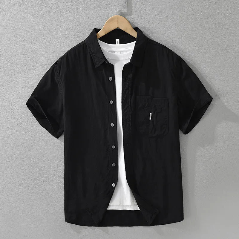 Women's loose black lyocell cardigan top with short sleeves on a hanger