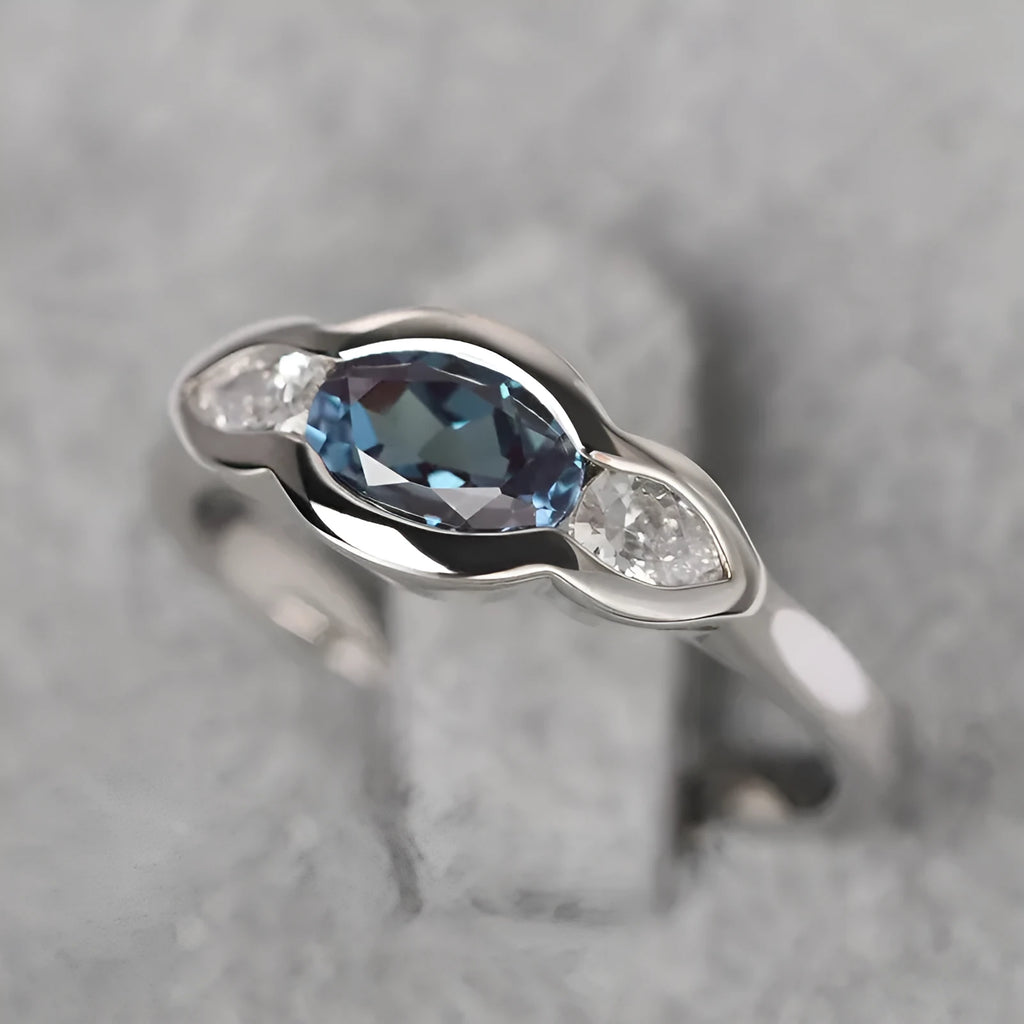 Geometric ellipse ring with zircon inlay in white gold colour on copper